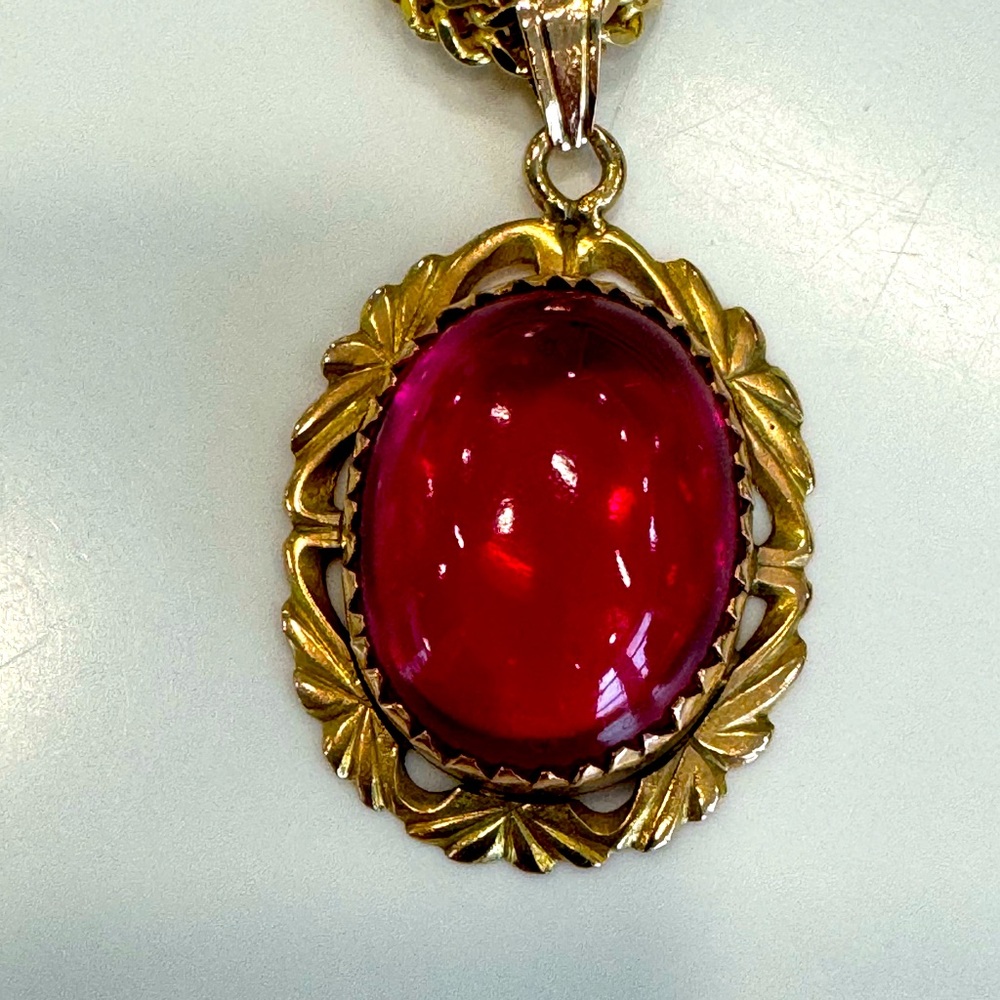 18kt gold with big garnet stone.
